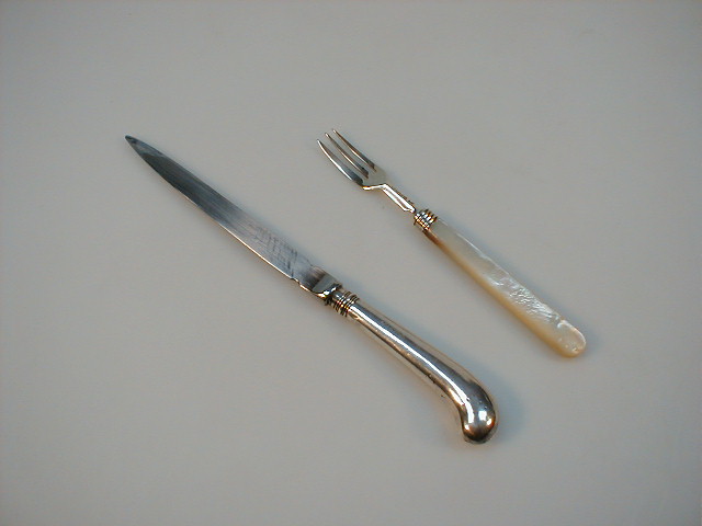 Appraisal: A Victorian silver pickle fork with mother-of-pearl handle and an