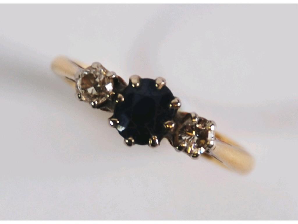 Appraisal: CT GOLD RING set with a centre sapphire and two