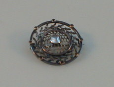 Appraisal: A small Edwardian silver circular brooch centrally set with a