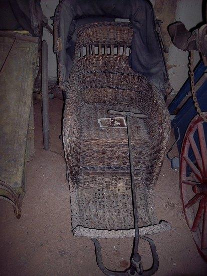 Appraisal: A Victorian bath chair the shaped wicker seat on an