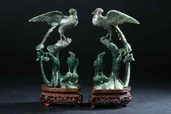 Appraisal: PAIR CHINESE GREEN JADE FIGURES OF BIRDS Perched on tree