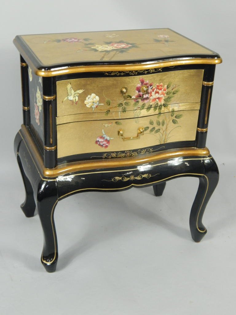 Appraisal: A gilt and black lacquered serpentine chest of two drawers