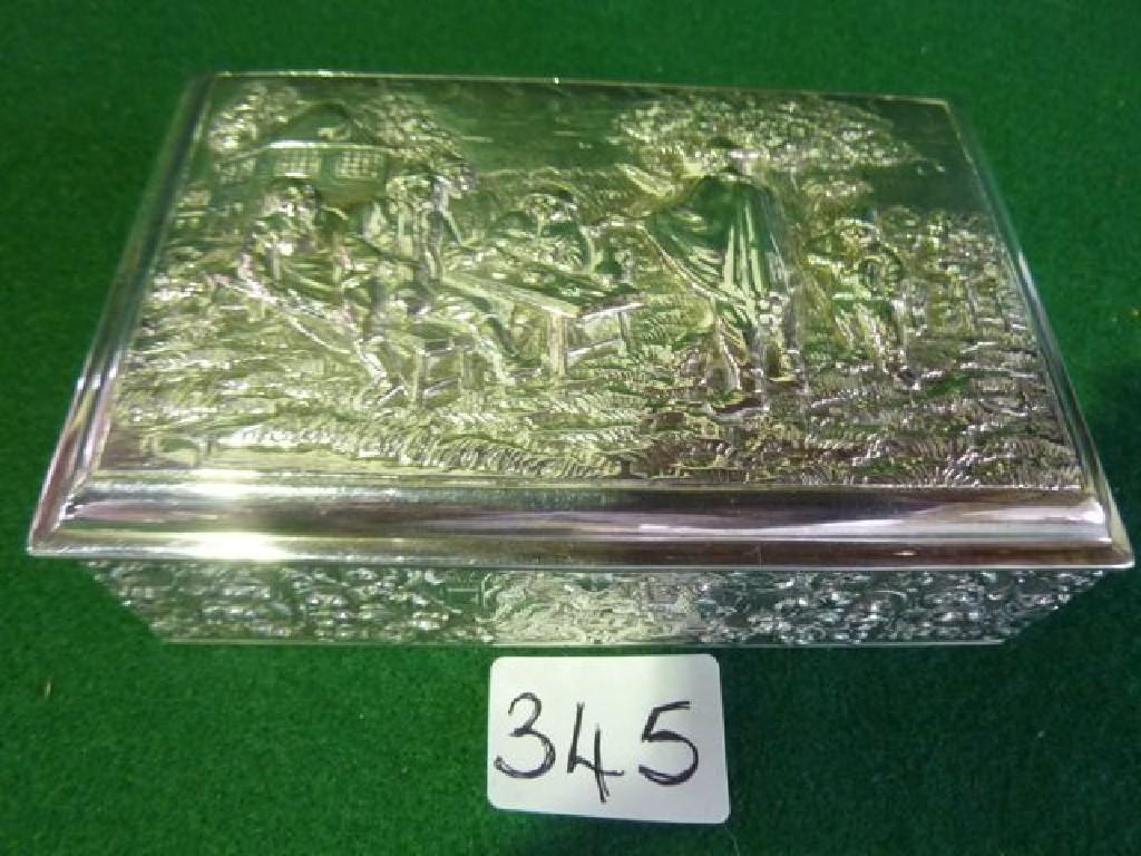 Appraisal: A silver cigarette box with embossed decoration of a rural