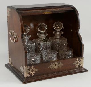 Appraisal: Early th century oak fronted tantalus with three decanters and