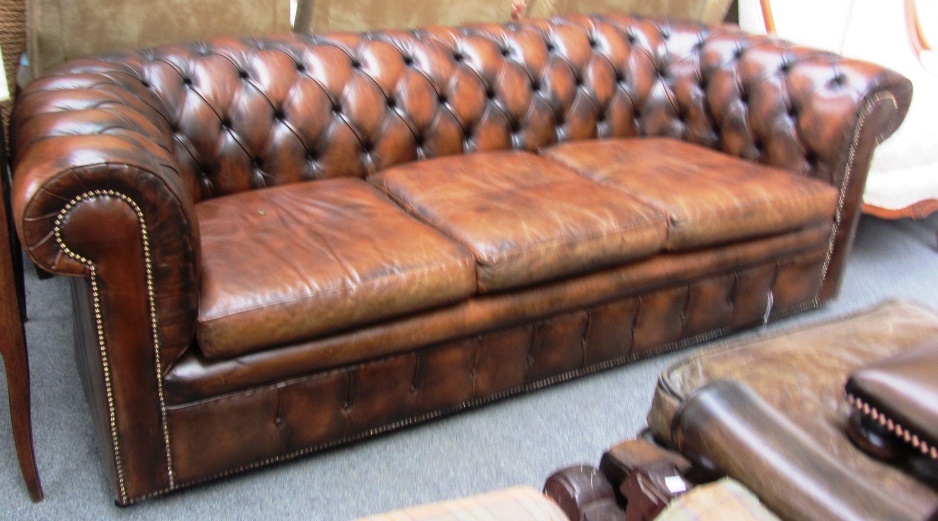 Appraisal: A th century brown leather three seater button back Chesterfield