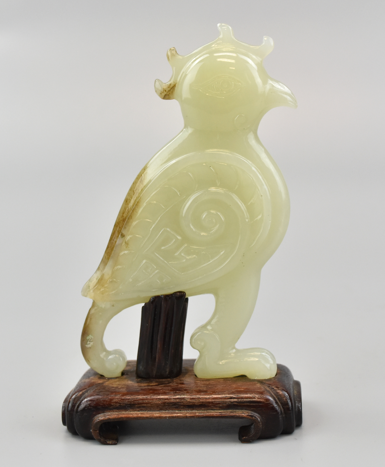 Appraisal: A beautiful Chinese carved parrot in white jade with custom