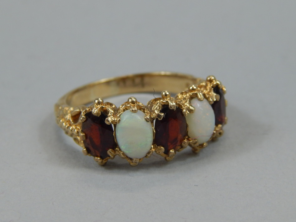 Appraisal: A ladies opal and garnet dress ring on a highly