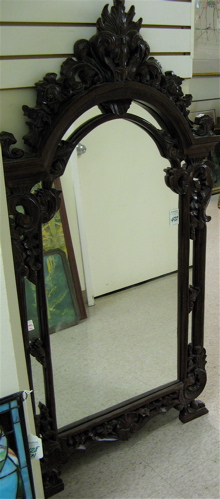 Appraisal: A MAHOGANY CARVED WALL MIRROR in the Victorian taste having