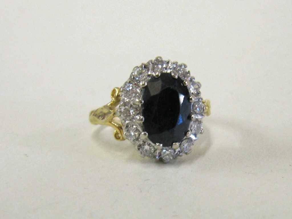 Appraisal: Eighteen carat gold sapphire and diamond cluster ring