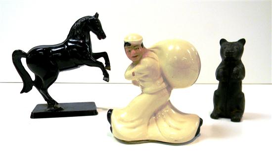 Appraisal: Three still banks a ceramic sailor carrying a bundle labeled