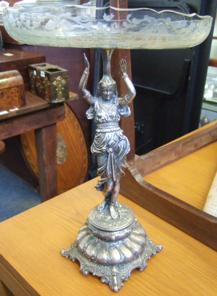 Appraisal: A plated metal table centrepiece fruitstand the column formed as