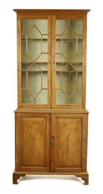 Appraisal: A mahogany bookcase on cabinet having a pair of astragal