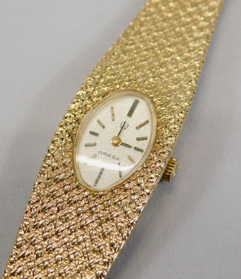 Appraisal: A ct gold ladies Omega wristwatch on bark effect strap