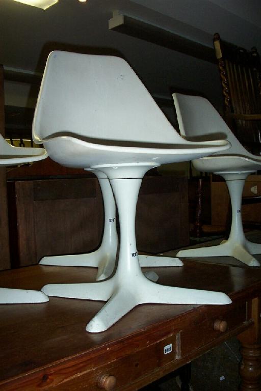 Appraisal: A set of four modern plastic swivel chairs of stylised