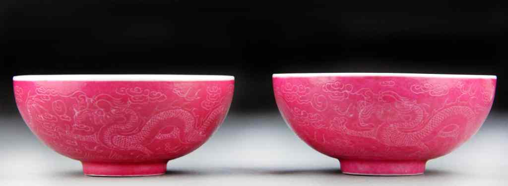 Appraisal: Pair Chinese Raspberry Glazed Porcelain BowlsEach finely incised depicting dragons