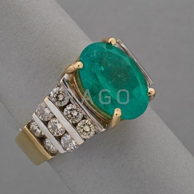 Appraisal: EMERALD AND DIAMOND K YELLOW GOLD RING Oval faceted emerald