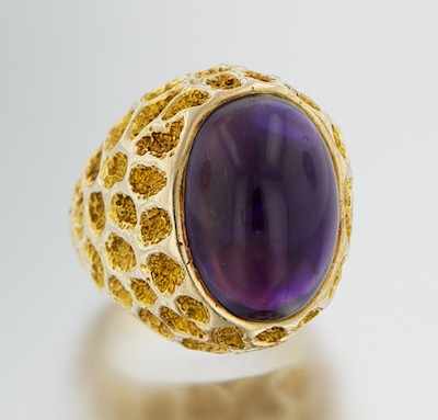 Appraisal: A Large Amethyst Cabochon Ring k yellow gold ring with