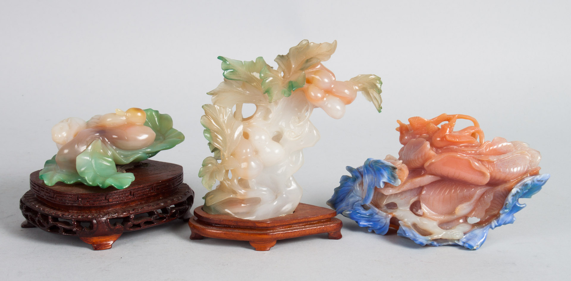 Appraisal: Three Chinese carved hardstone groups rabbits among bok choy fruit