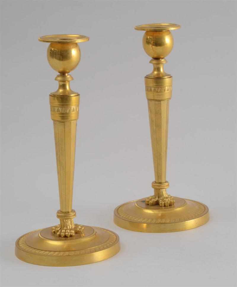 Appraisal: PAIR OF EMPIRE GILT-BRONZE CANDLESTICKS Each ten-sided tapered stem with