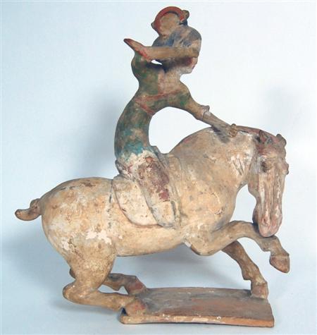 Appraisal: CHINESE EARTHENWARE PAINTED FIGURE OF A FEMALE POLO PLAYER MOUNTED