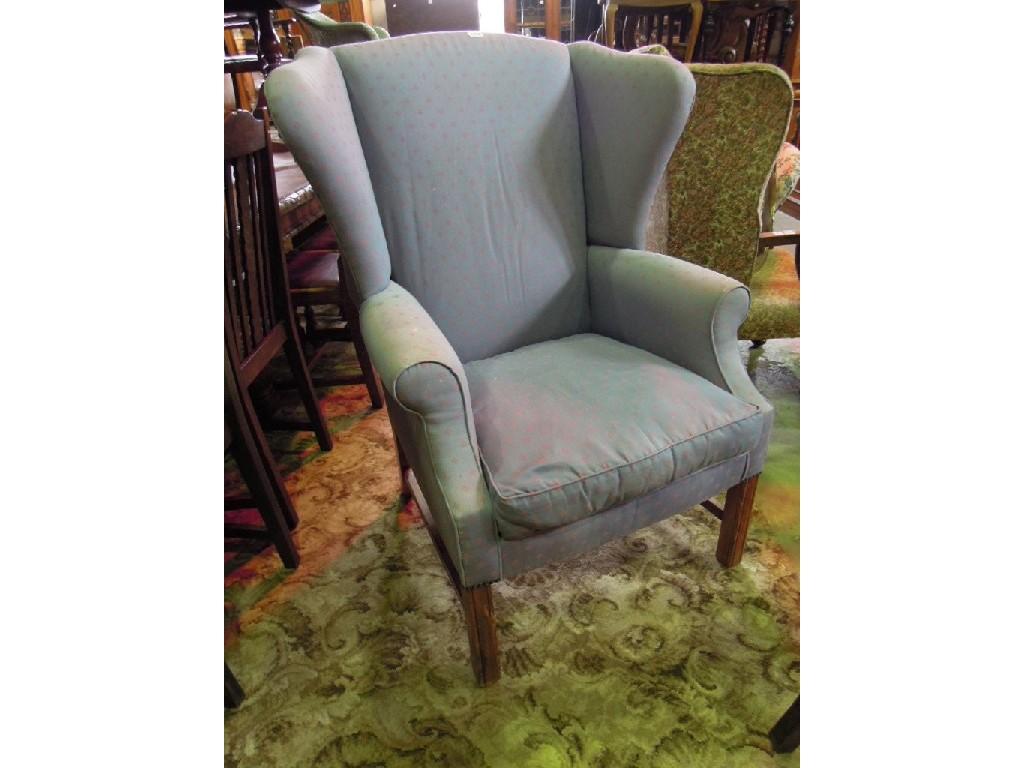 Appraisal: A Georgian style wing armchair with upholstered finish raised on