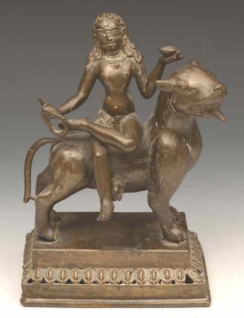 Appraisal: AN INDIAN BRONZE MODEL OF SHIVA sitting on a bull