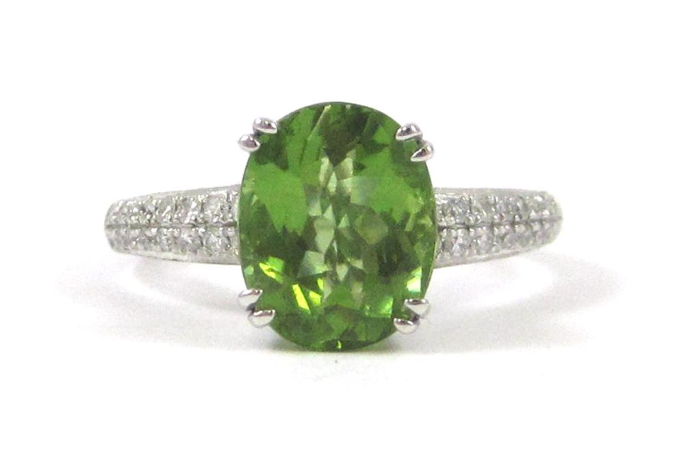 Appraisal: PERIDOT DIAMOND AND FOURTEEN KARAT GOLD RING The white gold