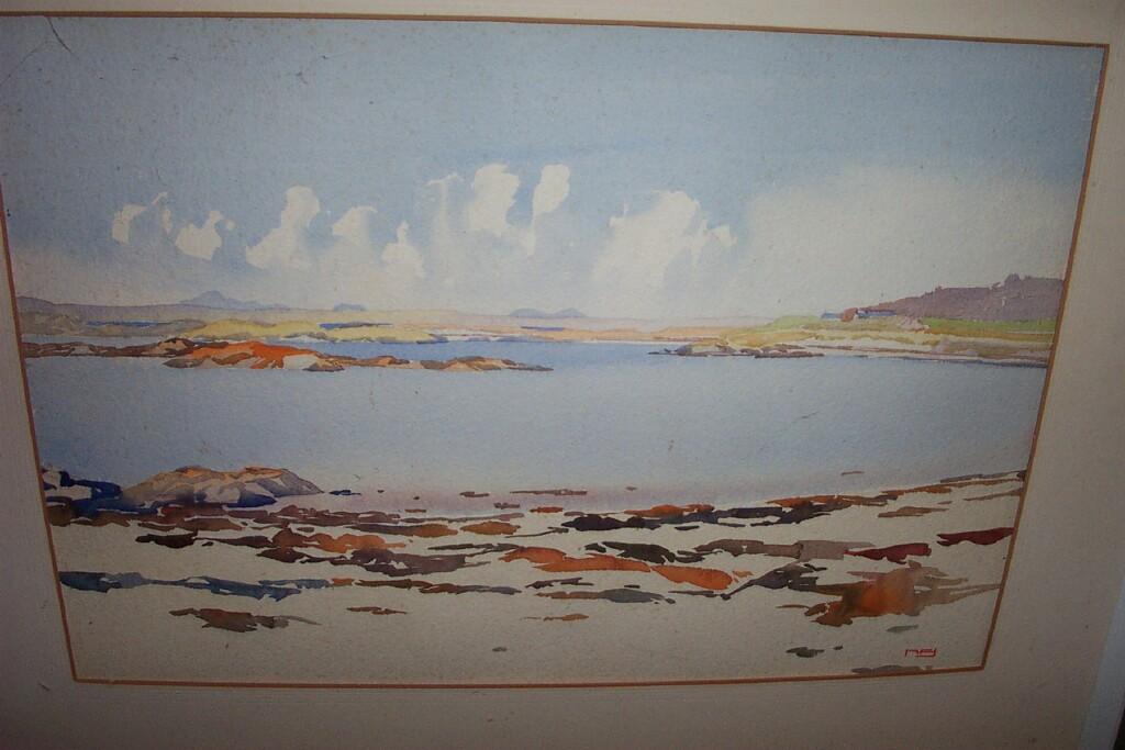 Appraisal: A watercolour of a coastal landscape with distant mountains signed