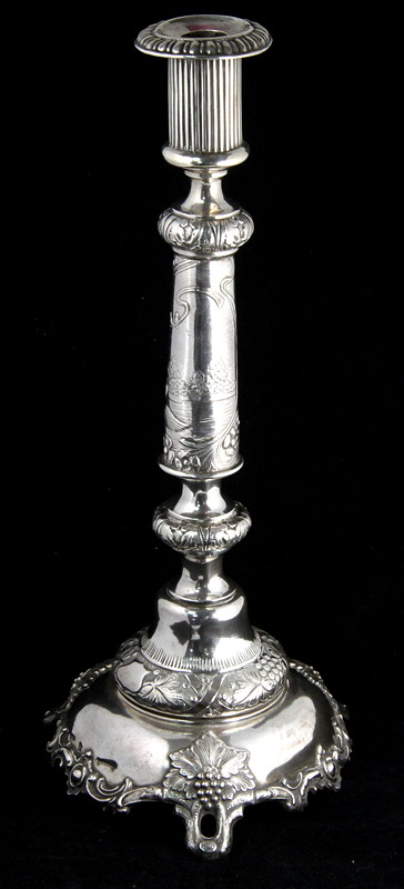 Appraisal: A Russian white metal candlestick of tapering cylindrical form decorated