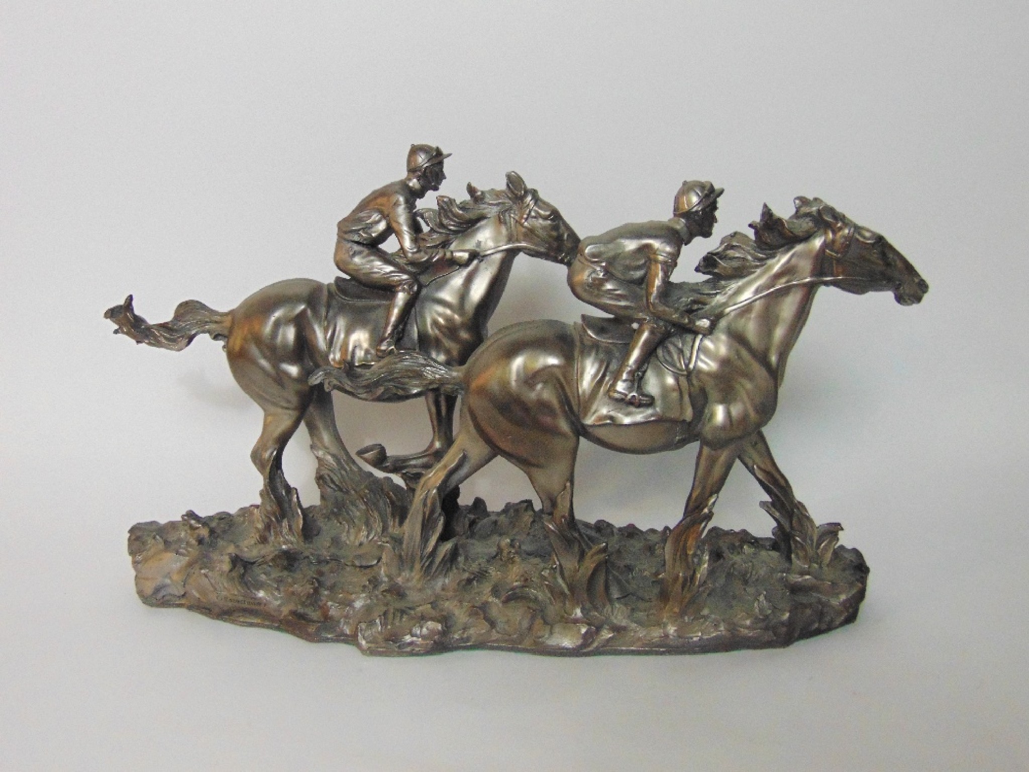 Appraisal: A composition sculptural model of two race horses and jockeys