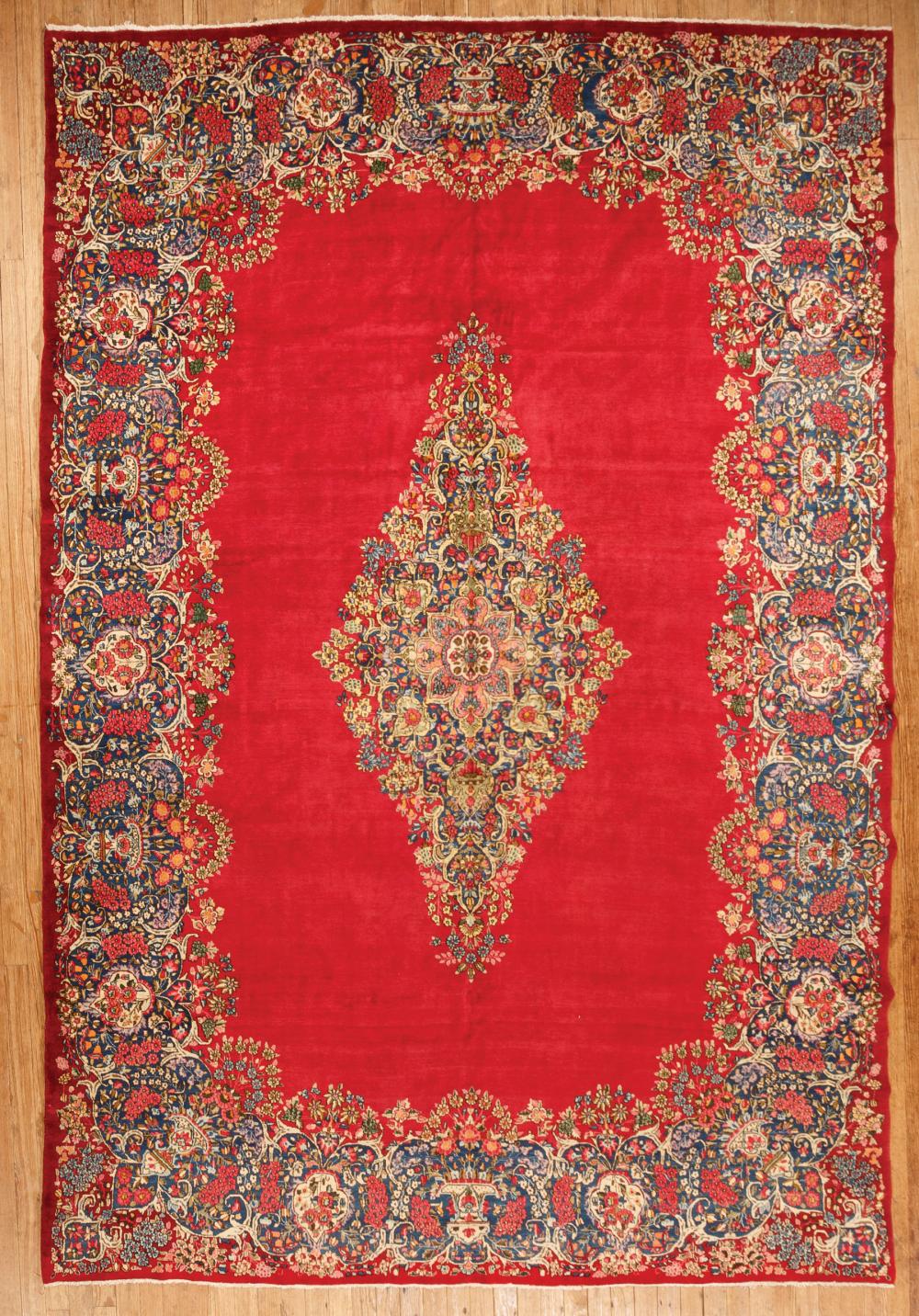 Appraisal: Persian Kerman Carpet red ground central medallion foliate design ft