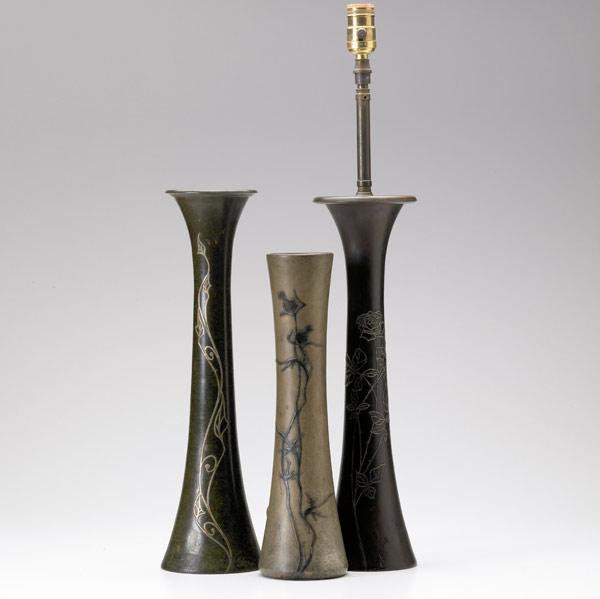 Appraisal: HEINTZ STERLING ON BRONZE Three tall vases with silver overlay