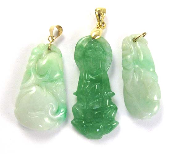 Appraisal: THREE CHINESE GREEN JADE PENDANTS carved with peaches eggplant and