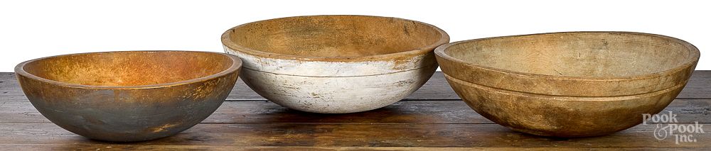 Appraisal: Group of three turned wooden bowls Group of three turned