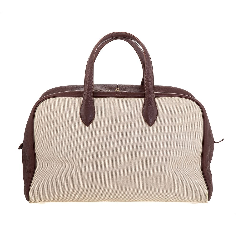 Appraisal: An Hermes Victoria Travel A natural coated canvas Hermes Victoria