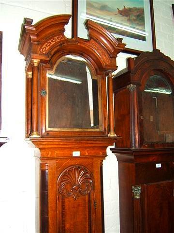 Appraisal: An oak long case clock case the break arch hood