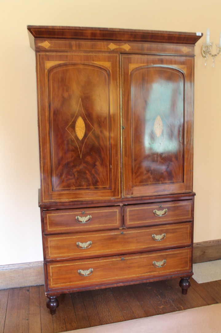 Appraisal: An early thC mahogany linen press with string and shell