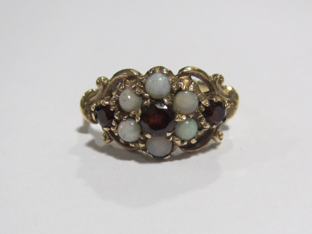 Appraisal: Nine carat gold opal and garnet cluster ring