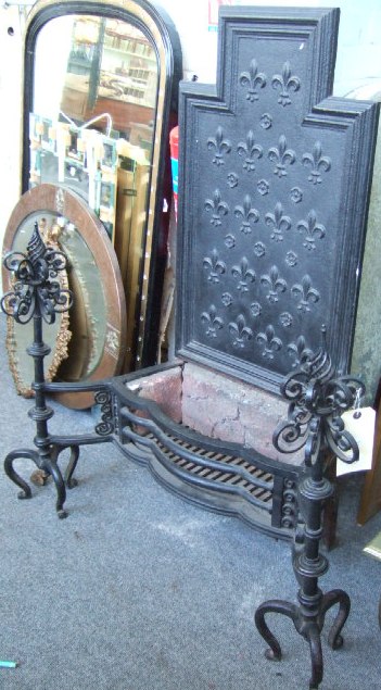 Appraisal: An Arts Crafts wrought and cast iron firegrate circa the