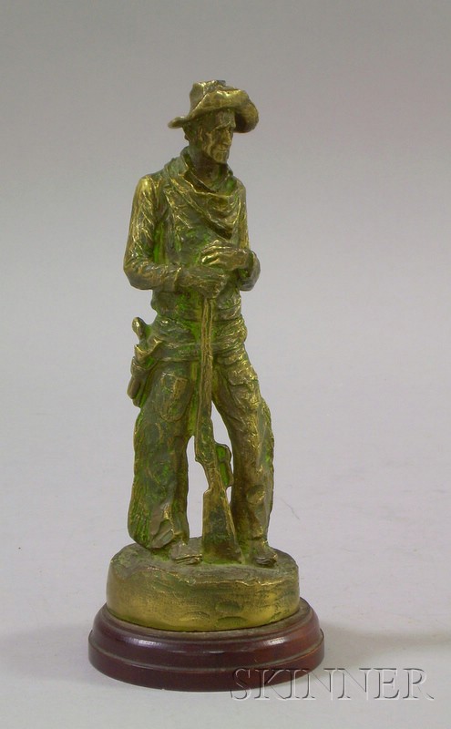 Appraisal: Small Bronze Sculpture of a Cowboy labeled on a wood