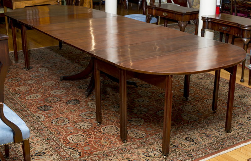 Appraisal: GEORGE III MAHOGANY TWO-PART DROP-LEAF DINING TABLE The rectangular top