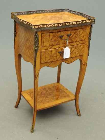 Appraisal: French style mixed wood single drawer stand with brass gallery