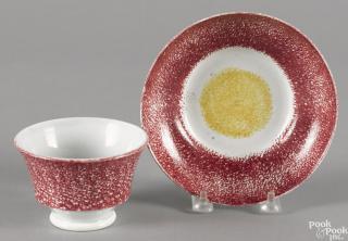 Appraisal: Red and yellow rainbow spatter bull's-eye cup and saucer Provenance