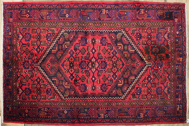 Appraisal: A MODERN HAMADAN RED GROUND RUG cm x cm