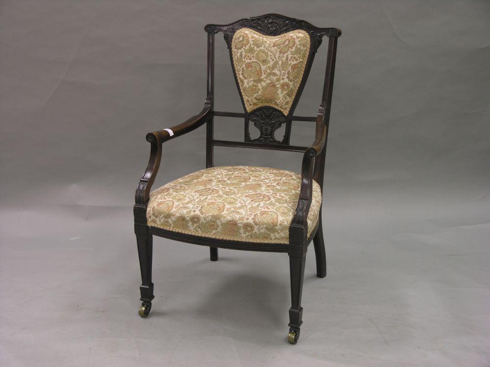 Appraisal: An Edwardian carved mahogany salon armchair carved with acanthus to