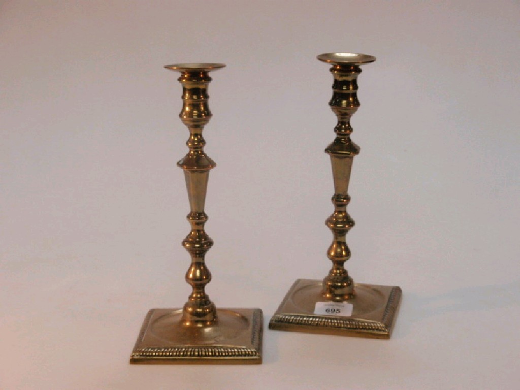 Appraisal: A pair of Georgian cast brass candle sticks with detachable