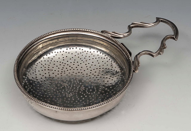 Appraisal: A GEORGE III SILVER LEMON STRAINER with drilled circular bowl