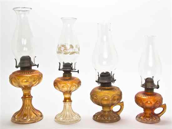 Appraisal: Four Carnival Glass Fluid Lamps each having a hurricane shade