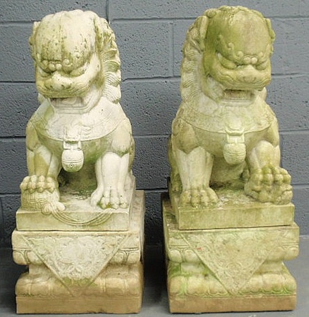 Appraisal: Pair of large carved limestone Foo dogs resting on plinths