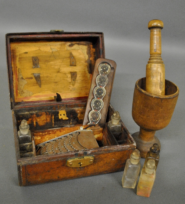 Appraisal: - Leather cased medical box with a wood mortar and